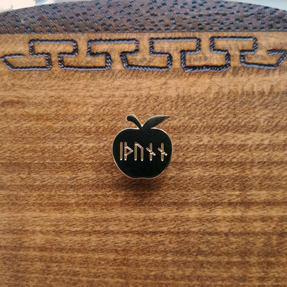 Enamel pin of Idunn's golden apple. Engraved on the apple is the word idunn in younger futhark. 