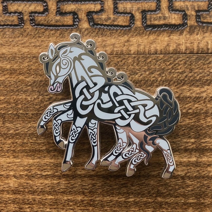 Silver-plated enamel pin of the Norse icon Sleipnir. Pin contains knotwork and is depicted as a eight-legged horse.