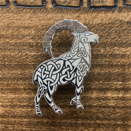 Norse god Thor, depicted as a goat enamel pin. The pin is silver plated and contains knotwork.