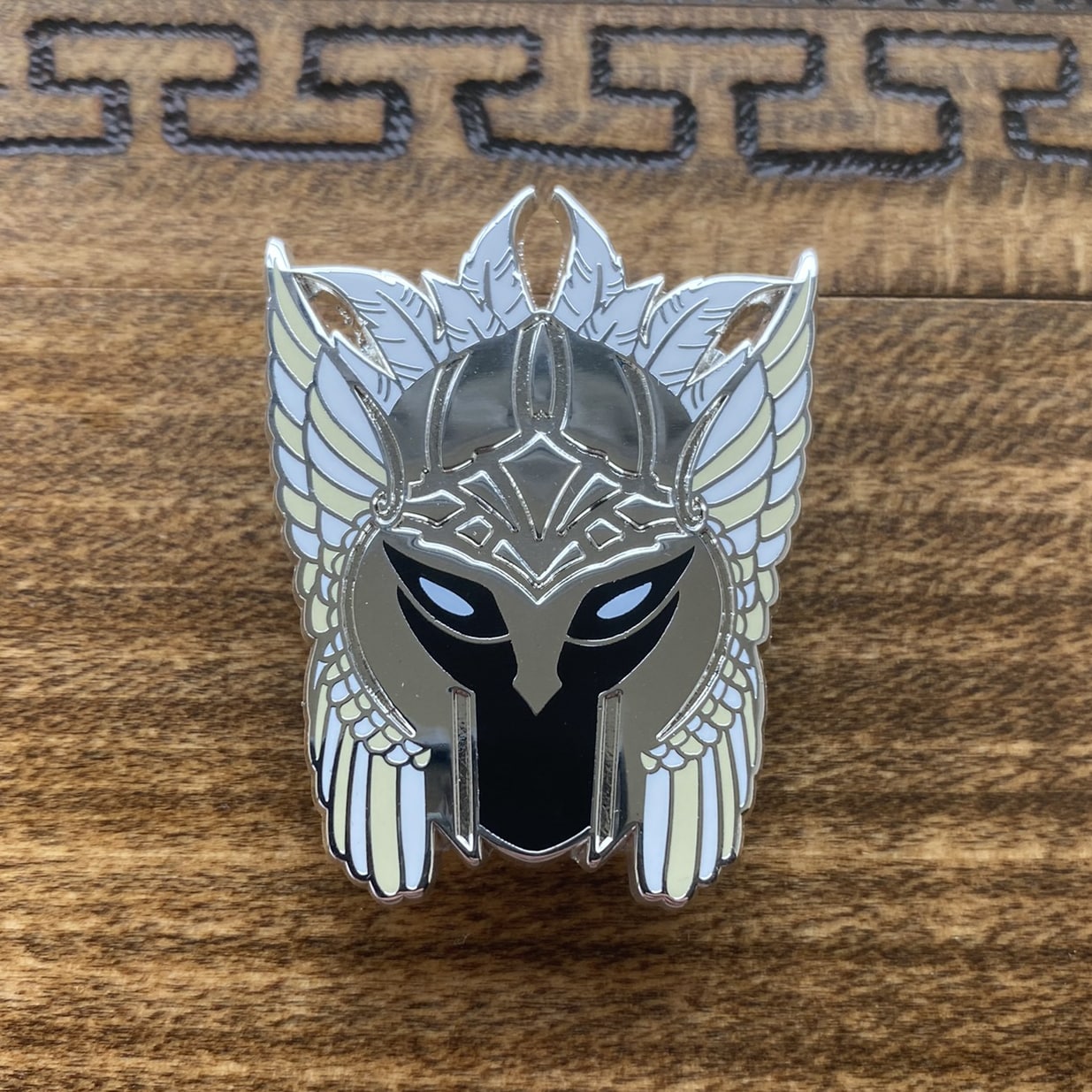 Silver-plated enamel pin of a valkyrie helmet, the Norse icons.