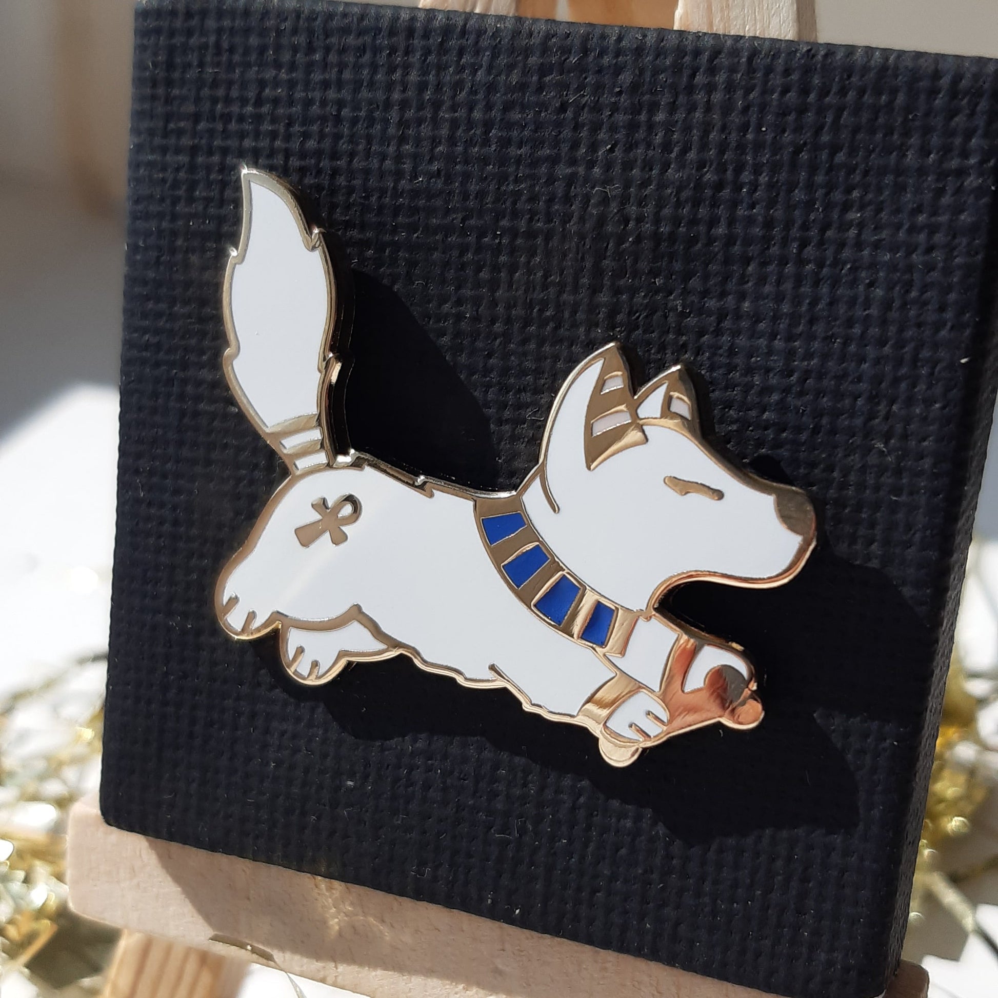 Gold-plated enamel pin of the Egyptian god Wepwawet, depicted as cute wolf. Pin contains ancient Egyptian symbols.