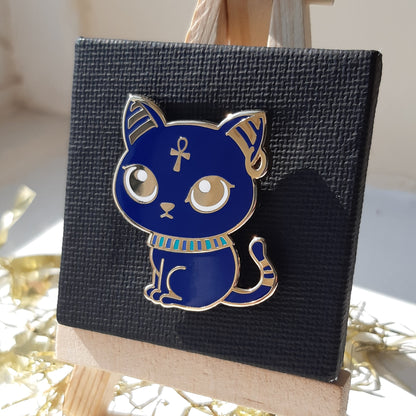 Gold-plated enamel pin of the Egyptian god Bastet, depicted as a blue cat. Pin contains ancient egyptian symbols.